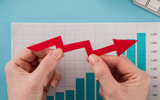 top-view-of-business-items-with-growth-chart-and-hands-holding-arrow